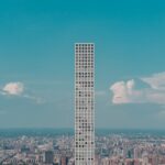 Aerial view of 432 Park Avenue towering over the urban landscape of New York City.